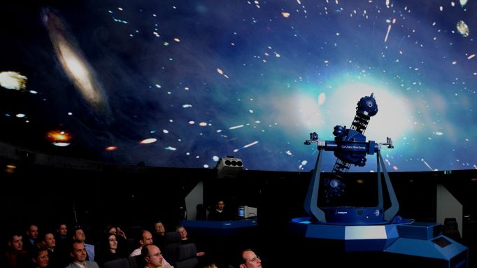 Photo of a group of people enjoying a planetarium presentation